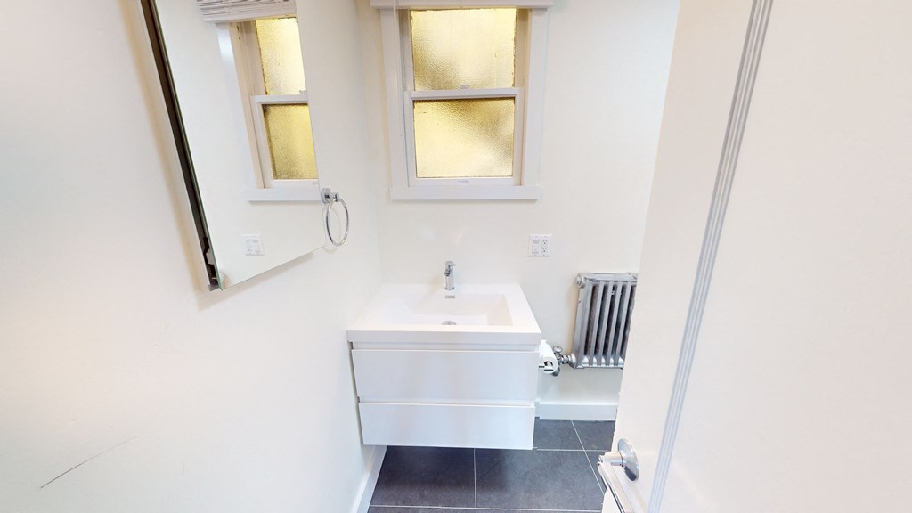 a small bathroom with a sink and a mirror