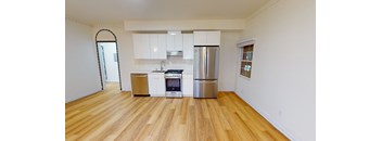 a kitchen with white cabinets and a stainless steel refrigerator