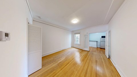 A room with wooden floors and white walls.