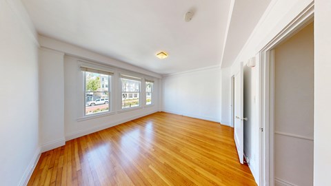 A room with wooden floors and white walls.