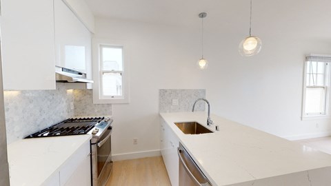 a kitchen with white marble counter tops and a sink