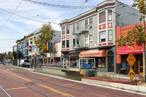 A street with a red line down the middle and a sign that says "The Twilight Zone".