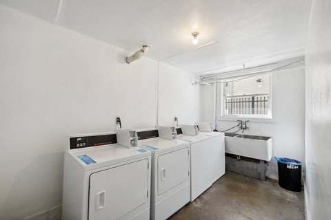 Laundry room with washes and dryers and a sink and a window