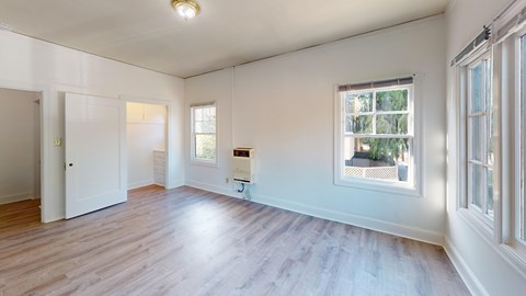 A room with a window and a door.