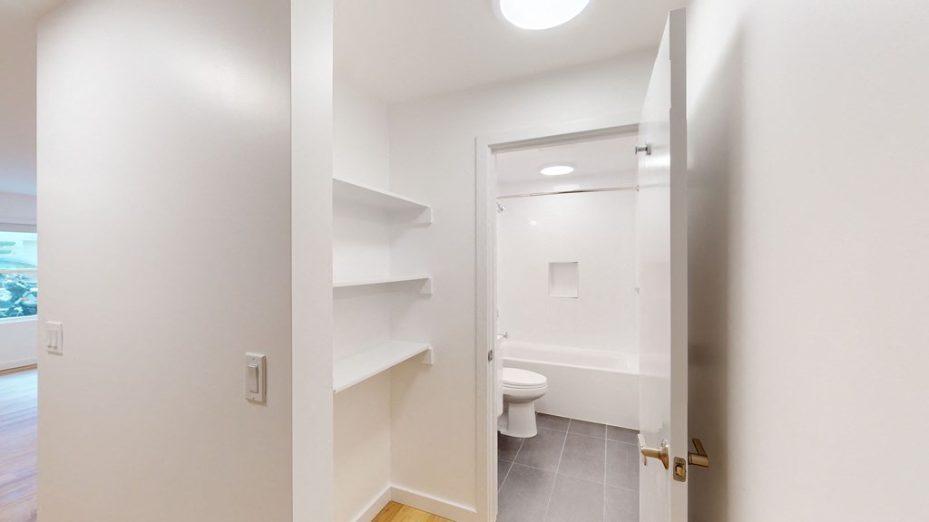 a bathroom with a toilet and a sink and a mirror