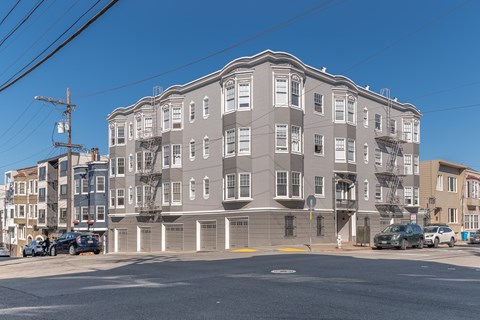 A large grey building with a flat roof and a yellow line in front of it.