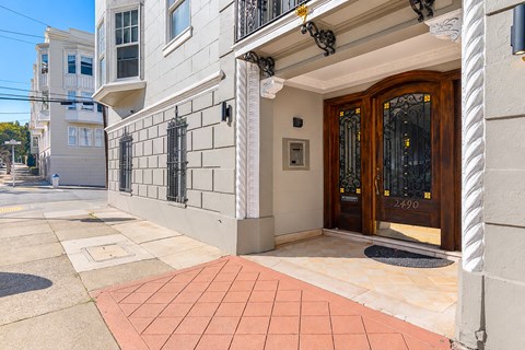 A building with a brown door and a black mailbox.