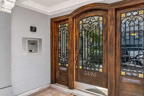 A brown door with the number 2490 on it and a sign that says "No Trespassing".