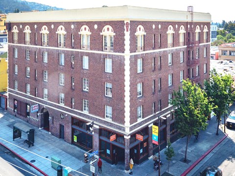 A red brick building with a white trim around the windows and roofline.