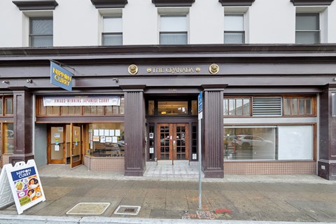 a view of the front of a restaurant on a city street