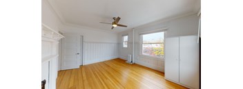 a living room with a ceiling fan and a window