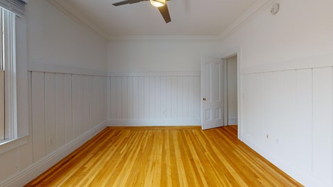 A room with wooden floors and white walls.