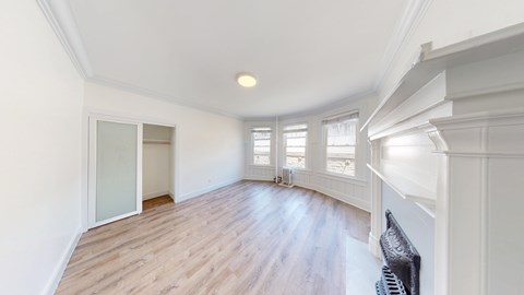A room with wooden floors and white walls.