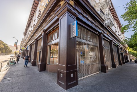 A Chase bank branch with a person walking by.
