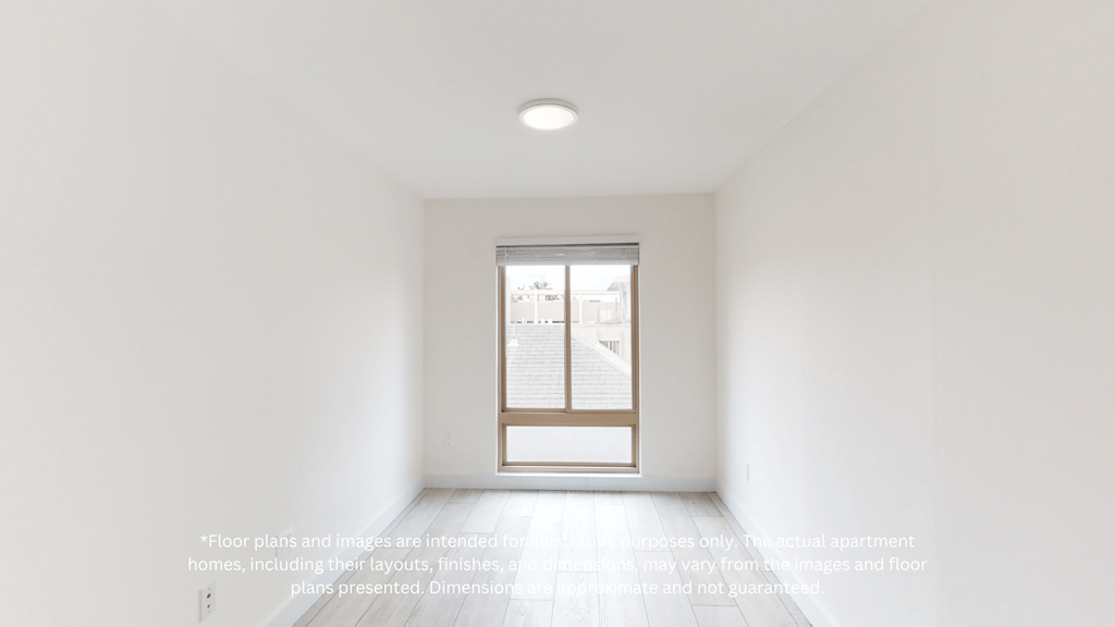 an empty white room with a window and a door