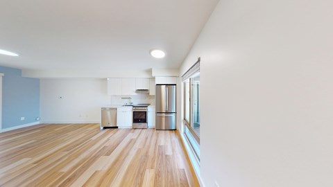 A kitchen with a stove top oven and a refrigerator.