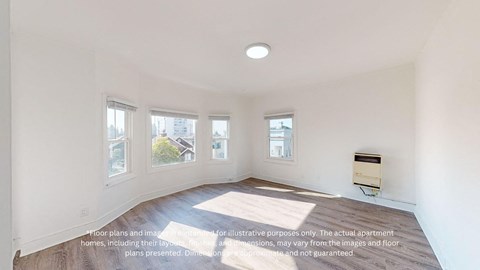 an empty living room with three windows and a wood floor
