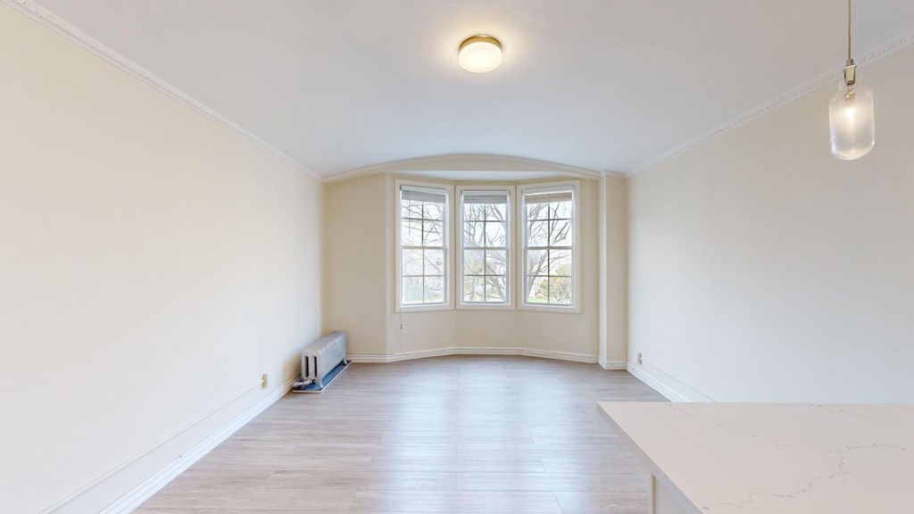 A room with a window and a bench.