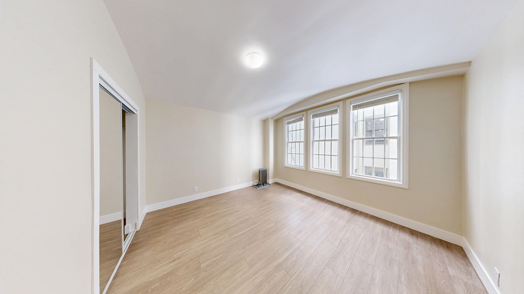 A room with a slanted ceiling and a window.