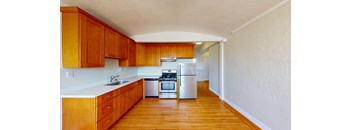 a kitchen with wooden cabinets and white appliances