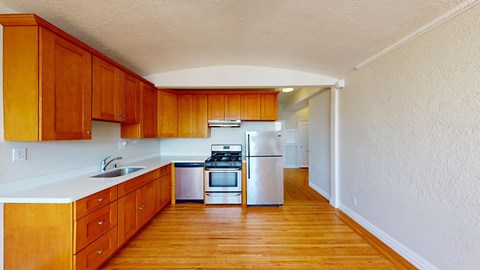 a kitchen with wooden cabinets and white appliances