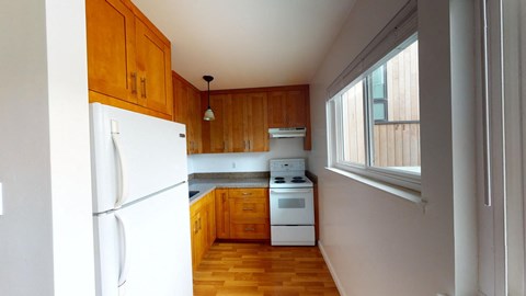 a kitchen with white appliances and wooden cabinets