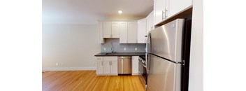 a kitchen with stainless steel appliances and white cabinets