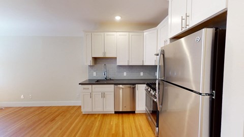 a kitchen with stainless steel appliances and white cabinets
