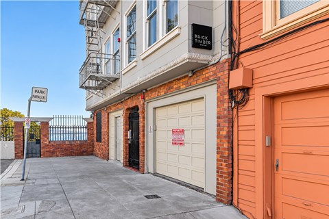 A building with a sign that says "PARKING" on the left side.