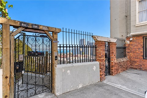 A black gate with the numbers 267 and 261 on it is closed.