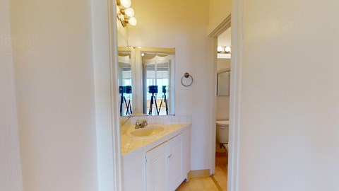 A bathroom with a sink and mirror.