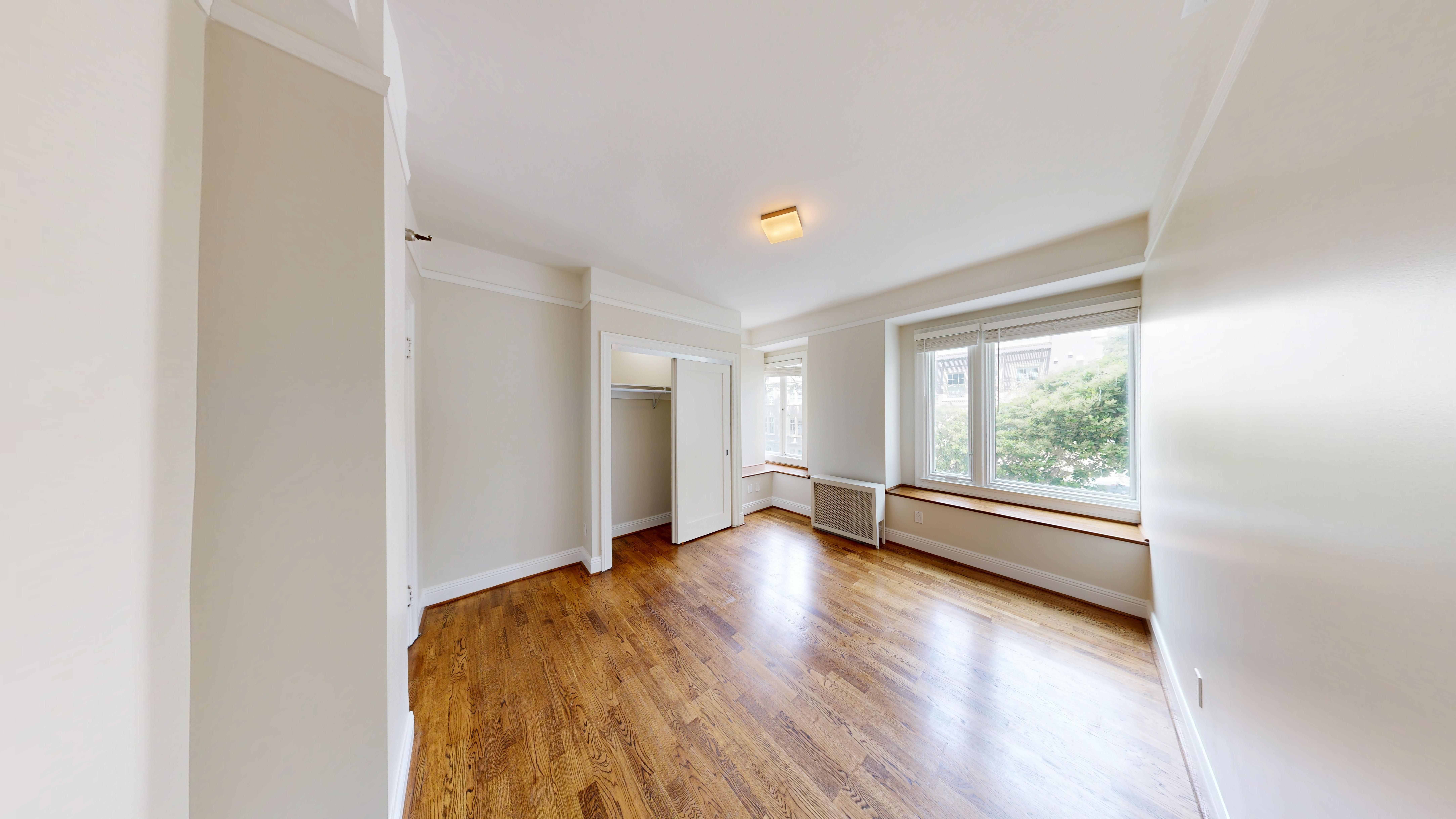 A room with wooden floors and white walls.