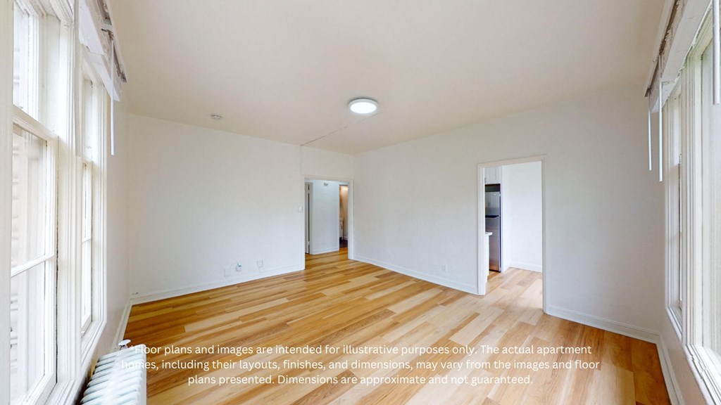 a renovated living room with white walls and wood floors