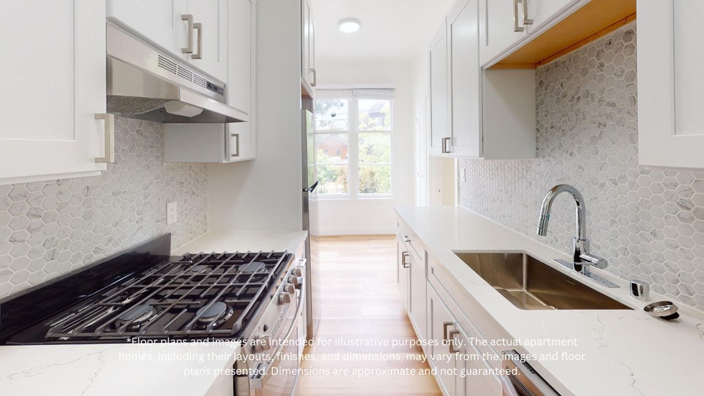 an image of a kitchen with white cabinets and a stove and sink