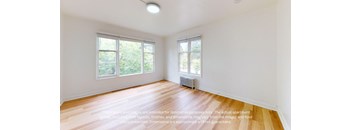 an empty living room with white walls and wood floors