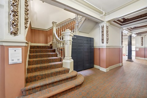 Grand hallway with a staircase adorned with a wooden railing
