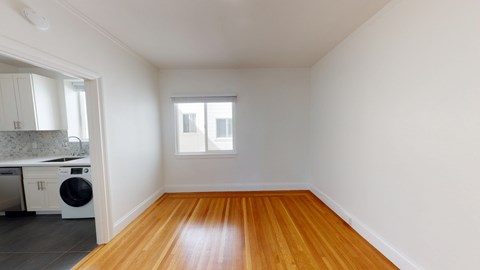 A room with wooden floors and white walls.