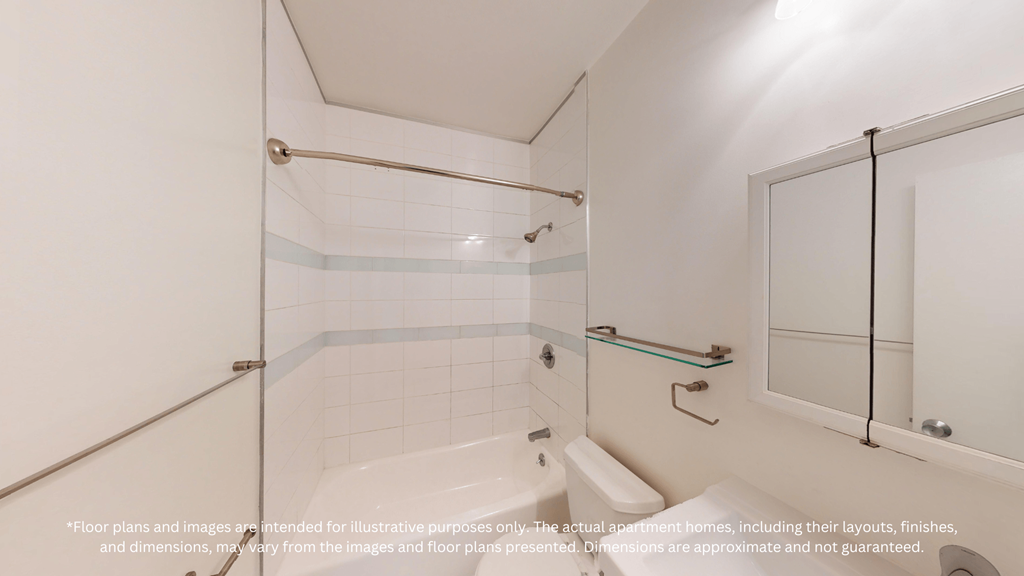 A white bathroom with a glass shower door and a white toilet.