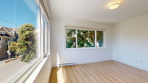A room with a window overlooking a street.