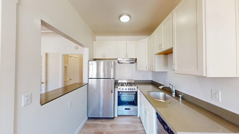 A kitchen with a stainless steel refrigerator and oven.
