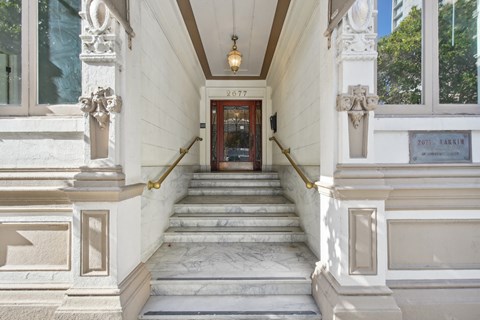 A white building with a red door and a sign that says "FUJI LARKIN".