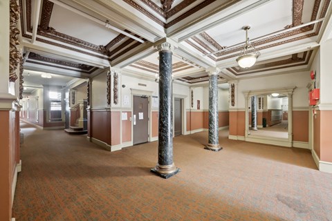 Grand hallway with a high ceiling illuminated by a chandelier