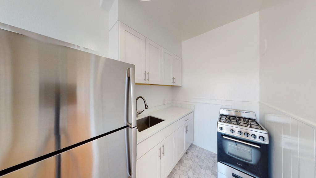 a kitchen with stainless steel appliances and white cabinets