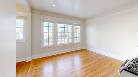 A room with wooden floors and a window.