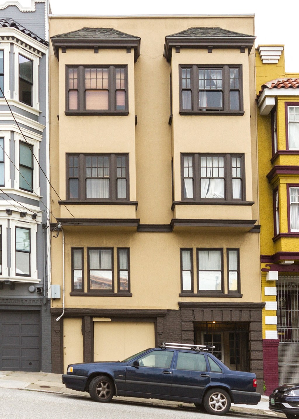 a car parked in front of a building on a street