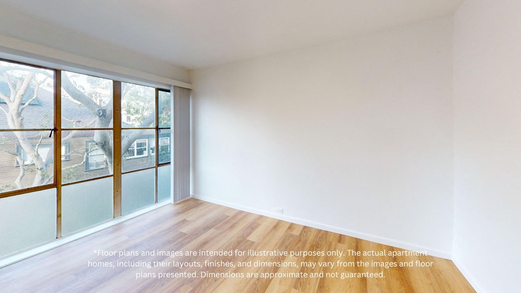 an empty room with white walls and a window