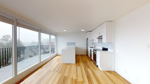 an open kitchen with a large window and a balcony
