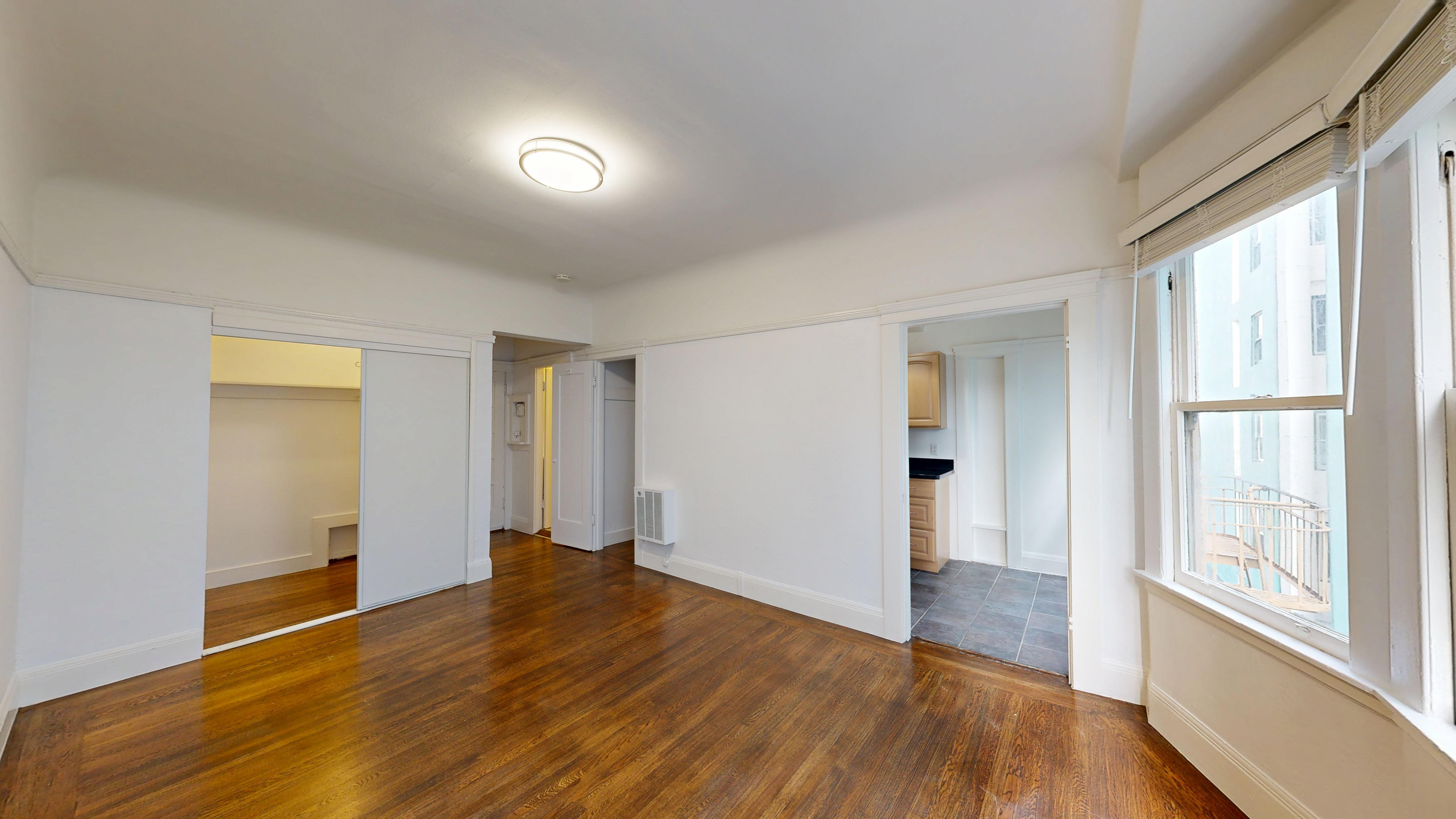 A room with wooden floors and white walls.