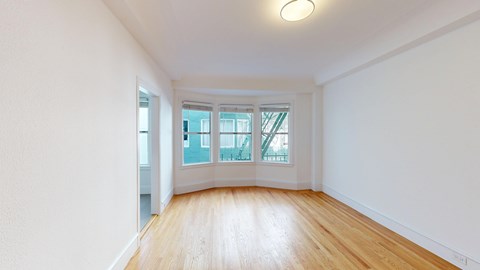 A room with wooden floors and white walls.