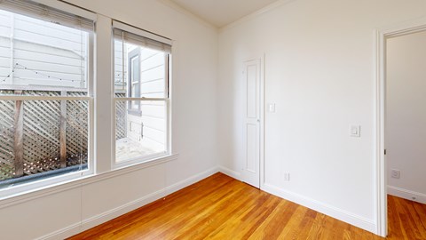 A room with wooden floors and white walls.